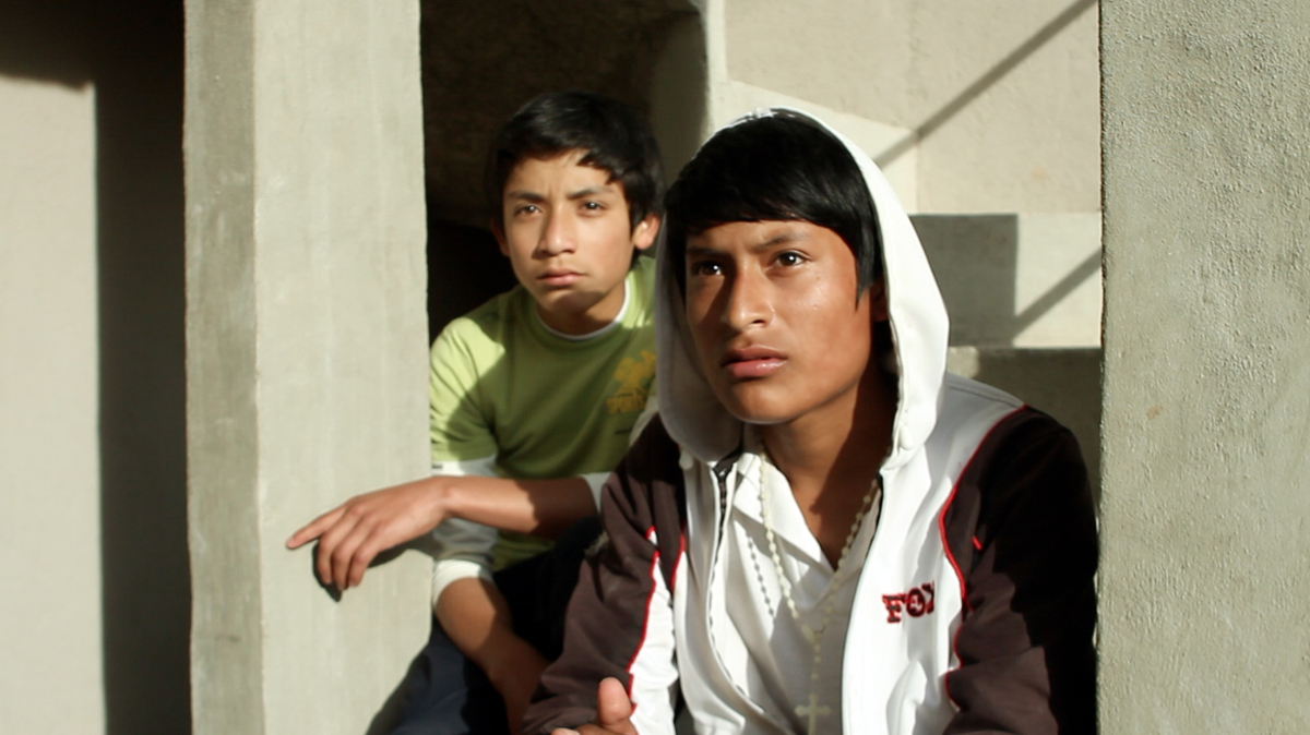 Two teenage boys sat on a concrete staircase