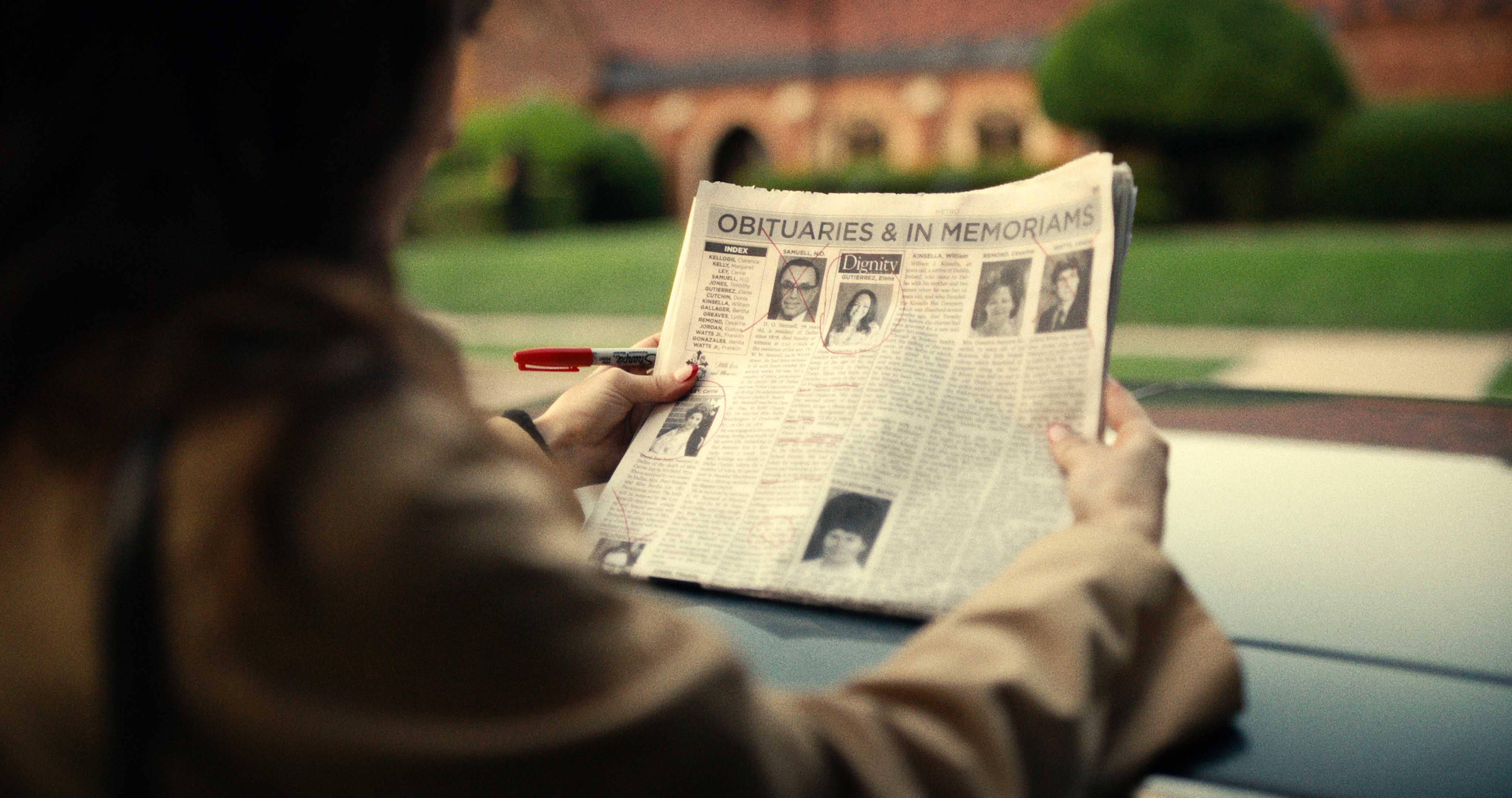 Natalia Villegas checks the obituary columns